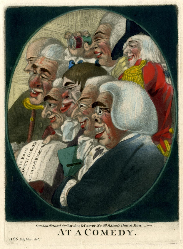 Eine Gruppe von Menschen, die in einem Kreis stehen, einer hält ein Blatt Papier in der Hand, lacht und amüsiert sich auf einem Comedy-Event.