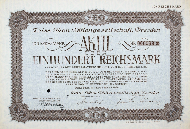 Alter deutscher Aktienchein für 100 Reichsmark mit schwarzem Rand und gedrucktem Text.